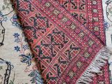 a close up of a rug with a red and black design on it