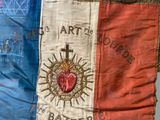 an old flag with a cross and a heart on it