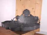 a metal sink sitting on top of a wooden table