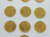several gold coins are arranged in a circle on a white surface