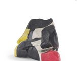 a black, white, and yellow sculpture of a dog