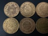 four different types of coins on a black surface