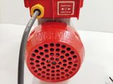 a red blow dryer sitting on top of a white table