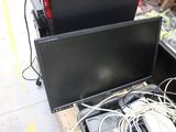 two monitors sitting on top of each other in a store
