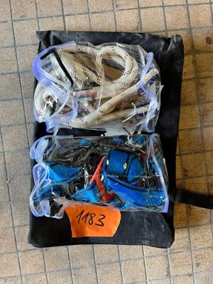 a black bag filled with assorted items on the floor