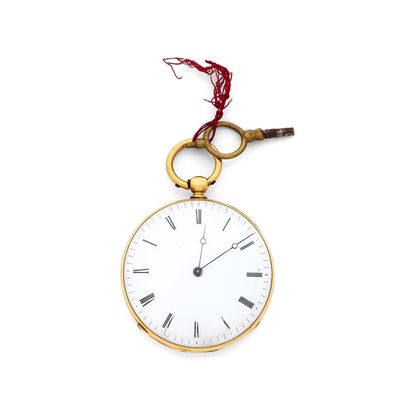 a gold pocket watch with a chain hanging from it ' s side