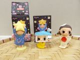 three little figurines that are sitting on a table