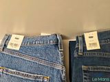 two pairs of levi ' s jeans are on display in a store