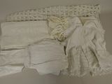 a lot of white clothing on a white surface