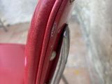 a red chair that is sitting in front of a wall