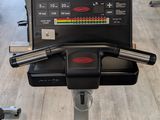 a row of stationary exercise bikes in a gym