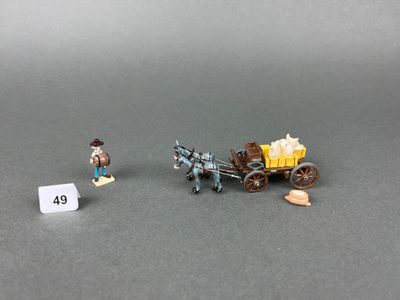 a small figurine of a man and a horse drawn carriage