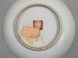 a white plate with a small piece of paper on it