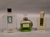 three bottles of perfume sitting next to each other on a table