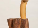 a wooden object that looks like a banana and a banana peeler