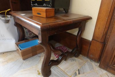 a small wooden table with a box on top of it