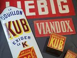 a lot of old signs on a bed in a room