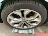 a close up of a car ' s tire on the ground