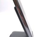 a cell phone on a stand on a white surface