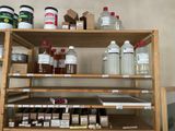 a shelf with many bottles and containers on top of it