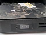 a black laptop with a sticker on it sitting on a table