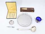 a silver tray with spoons, spoons, and other items on it