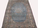 un tapis persan ancien avec une bordure bleue et rouge