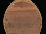 a wooden mirror with a chain around it on a stand