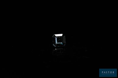 an image of a diamond in the dark on a black surface
