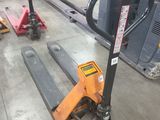 a fork lifter sitting on the floor in a warehouse