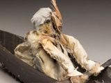 an image of a sculpture of a person in a boat