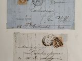 two pieces of old paper with a stamp on them on top of a table