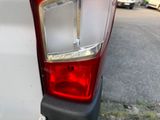 a close up of a car ' s tail light on the side of the road