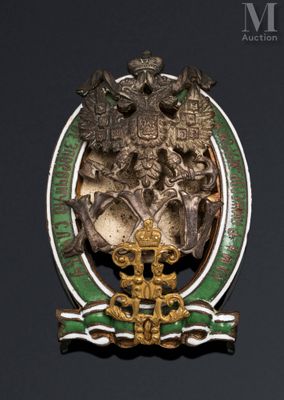 an image of a green and gold broochle with a coat of arms on it