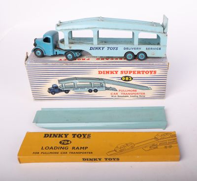 two toy trucks are sitting next to each other on a white surface