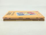 two books sitting on top of each other on a white surface