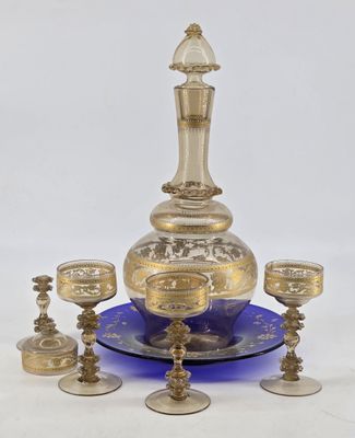 brass and blue glass decanter set with four cups and a decanter