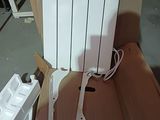 a white electric radiator sitting in a cardboard box