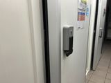 a white door with a black handle in a bathroom
