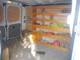 a white van that has some shelves in the back of it