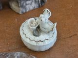 a small white box with two birds on it