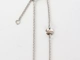 a close up of a silver chain with a heart on it