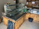 a glass display case with a chalk board sign on it