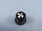 a close up of a metal screw with a star on it