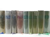 books are lined up in a row on a white surface