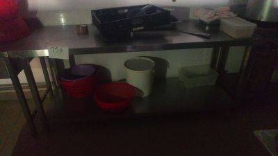 a kitchen with a stove, sink, and other items on the counter