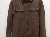 the jacket is hanging on a hanger on the wall
