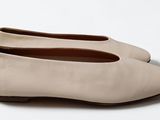 pair of women ' s shoes on a white surface with a white background