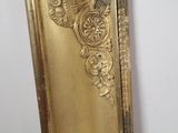 a mirror that has a gold frame on it
