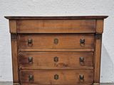 an old wooden chest of drawers sitting on top of a cement floor